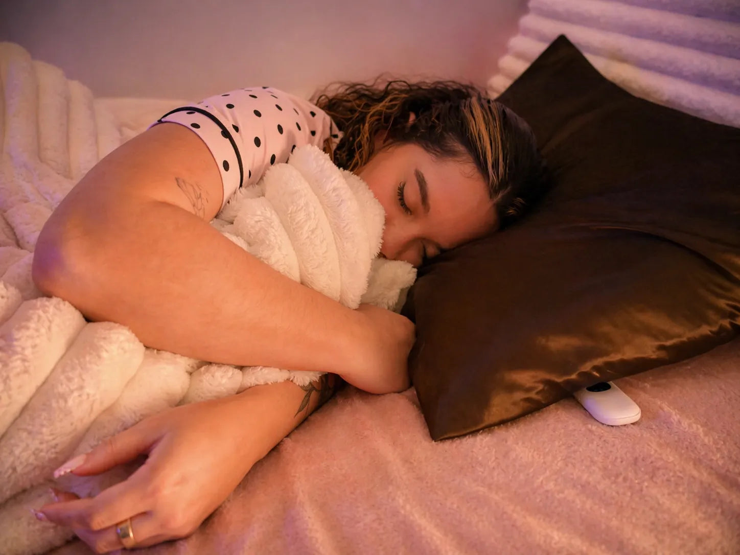Overhead view of a person sleeping peacefully with Lullabar under their pillow
